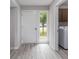 Welcoming entryway with durable gray floors, natural light from the front door and window, and nearby laundry room at 800 Egret Circle # 53, Little River, SC 29566