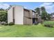 Exterior side view of home with manicured lawn, an AC unit, privacy fences, and mature shade trees at 800 Egret Circle # 53, Little River, SC 29566