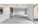 Spacious living room with modern flooring, a staircase, and sliding glass doors to the outdoor space at 800 Egret Circle # 53, Little River, SC 29566