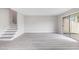 Bright living room with modern flooring, a staircase, and sliding glass doors to the outdoor space at 800 Egret Circle # 53, Little River, SC 29566