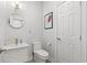 Elegant half-bathroom with white fixtures, modern lighting, and stylish decor at 867 Cardinal Pl., North Myrtle Beach, SC 29582