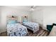 Bright bedroom featuring two twin beds, a ceiling fan, and ample natural light, perfect for relaxation and rest at 867 Cardinal Pl., North Myrtle Beach, SC 29582
