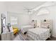 Charming bedroom showcasing two twin beds, a vaulted ceiling, and a cozy sitting area, perfect for guests at 867 Cardinal Pl., North Myrtle Beach, SC 29582