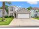 Charming two-story home with light brick, well-maintained landscaping, and a two-car garage at 867 Cardinal Pl., North Myrtle Beach, SC 29582