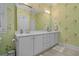 Bathroom with double sinks, large mirror, and light green floral wallpaper at 100 Brookgreen Trace Pl., Pawleys Island, SC 29585