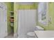 Bathroom features a shower-tub combo with toilet and storage shelving at 100 Brookgreen Trace Pl., Pawleys Island, SC 29585