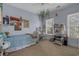 Well-lit bedroom with unique wall decor, carpet flooring, and bright natural light at 100 Brookgreen Trace Pl., Pawleys Island, SC 29585