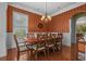 Traditional dining room featuring wainscoting, hardwood floors, and elegant chandelier at 100 Brookgreen Trace Pl., Pawleys Island, SC 29585