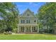 Lovely two-story home with a welcoming front porch, perfect for enjoying the outdoors at 100 Brookgreen Trace Pl., Pawleys Island, SC 29585