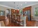 Kitchen island boasts stainless appliances and granite countertops with pendant lighting and bar seating at 100 Brookgreen Trace Pl., Pawleys Island, SC 29585