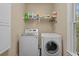 Laundry room features a washing machine and dryer with storage shelf at 100 Brookgreen Trace Pl., Pawleys Island, SC 29585