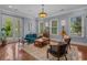Stylish living room featuring hardwood floors, large windows, comfortable seating, and modern decor at 100 Brookgreen Trace Pl., Pawleys Island, SC 29585