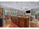 Open floor plan with kitchen island, stainless appliances, and a view into the living room at 100 Brookgreen Trace Pl., Pawleys Island, SC 29585