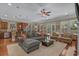 Bright living area featuring large windows, hardwood floors, and a comfortable sectional sofa at 100 Brookgreen Trace Pl., Pawleys Island, SC 29585
