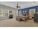 Spacious bedroom featuring a king-size bed, large windows, and stylish decor at 100 Brookgreen Trace Pl., Pawleys Island, SC 29585