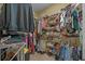 Organized walk-in closet features shelving for shoes and clothes racks for ample storage at 100 Brookgreen Trace Pl., Pawleys Island, SC 29585