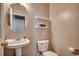Cozy bathroom featuring a pedestal sink, oval mirror, and convenient shelving at 100 Culpepper Way # 1002, Myrtle Beach, SC 29579