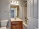 This bathroom has a wood vanity, toilet, and tub with a shower with neutral paint at 100 Culpepper Way # 1002, Myrtle Beach, SC 29579