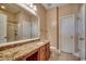 Bathroom featuring a granite countertop, tiled floor, and glass shower at 100 Culpepper Way # 1002, Myrtle Beach, SC 29579