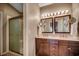 Bathroom with a double vanity, mirrors, and a glass shower door at 1010 Swan Lake Dr., North Myrtle Beach, SC 29582