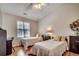 Bright bedroom with two twin beds, wood floors, and a vaulted ceiling with a fan at 1010 Swan Lake Dr., North Myrtle Beach, SC 29582