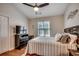Cozy bedroom features a ceiling fan, wood floors, and a window with natural light at 1010 Swan Lake Dr., North Myrtle Beach, SC 29582