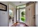 Inviting foyer features hardwood floors, neutral paint, glass front door, and view of dining room at 1010 Swan Lake Dr., North Myrtle Beach, SC 29582