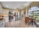 Bright and airy kitchen featuring stainless steel appliances, white cabinetry, and tiled flooring at 1010 Swan Lake Dr., North Myrtle Beach, SC 29582