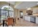 Bright eat-in kitchen with stainless appliances, white cabinets, and sunlit breakfast nook at 1010 Swan Lake Dr., North Myrtle Beach, SC 29582