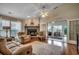 Cozy living room with a fireplace, ceiling fan, hardwood floors, and a sliding glass door at 1010 Swan Lake Dr., North Myrtle Beach, SC 29582