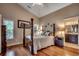 Comfortable main bedroom with a four-poster bed, hardwood floors, and ensuite bath at 1010 Swan Lake Dr., North Myrtle Beach, SC 29582