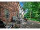 Relaxing brick patio with outdoor seating, set against a red brick house and lush greenery at 1010 Swan Lake Dr., North Myrtle Beach, SC 29582