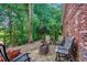 Inviting brick patio with outdoor seating and tables, surrounded by trees and shrubs at 1010 Swan Lake Dr., North Myrtle Beach, SC 29582