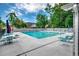 Relaxing community pool area with chairs and umbrellas for a serene outdoor experience at 1010 Swan Lake Dr., North Myrtle Beach, SC 29582