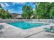 Community pool surrounded by lounge chairs and lush greenery at 1010 Swan Lake Dr., North Myrtle Beach, SC 29582