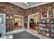 Bright sitting area with brick walls, built-in bookshelves, and an open view to other rooms at 1010 Swan Lake Dr., North Myrtle Beach, SC 29582