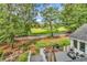 Scenic backyard view overlooking a golf course, featuring a white picket fence and mature trees at 1064 Links Rd., Surfside Beach, SC 29575