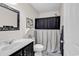 Classic bathroom with a marble vanity, framed mirror, and shower with a decorative curtain at 1064 Links Rd., Surfside Beach, SC 29575
