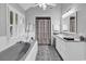 Bright bathroom with soaking tub, double vanity, and plantation shutters at 1064 Links Rd., Surfside Beach, SC 29575