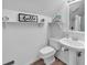 Cozy bathroom with pedestal sink, decorative shelves, and nautical-themed accents at 1064 Links Rd., Surfside Beach, SC 29575