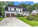 Charming two-story home with a well-manicured lawn, two-car garage, and inviting front porch at 1064 Links Rd., Surfside Beach, SC 29575
