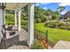 Inviting front porch with comfortable seating and views of the beautifully landscaped front yard at 1064 Links Rd., Surfside Beach, SC 29575