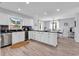 Bright kitchen with white cabinets, stainless steel appliances, a view of backyard, and adjacent dining area at 1064 Links Rd., Surfside Beach, SC 29575