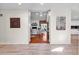 Open-concept living room with hardwood floors, white walls, and artwork on the walls at 1064 Links Rd., Surfside Beach, SC 29575