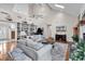 Bright living room with vaulted ceilings, bookshelves, hardwood floors, and comfortable seating at 1064 Links Rd., Surfside Beach, SC 29575