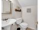 Cozy powder room featuring pedestal sink, toilet, and decorative mirror at 1064 Links Rd., Surfside Beach, SC 29575