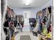 Spacious walk-in closet with ample storage, multiple racks, and a window for natural light at 1064 Links Rd., Surfside Beach, SC 29575