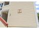 Apartment building entrance with a beige exterior and a sign with the letter F at 1100 Possum Trot Rd. # F218, North Myrtle Beach, SC 29582
