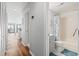 Hallway features wood flooring, open floor plan, and access to a bathroom at 1100 Possum Trot Rd. # F218, North Myrtle Beach, SC 29582