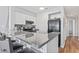 Modern kitchen featuring granite countertops, white cabinets, stainless steel range, and a black refrigerator at 1100 Possum Trot Rd. # F218, North Myrtle Beach, SC 29582
